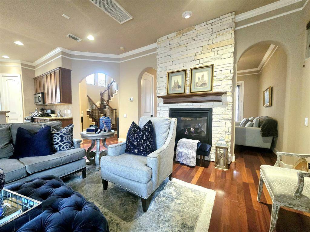 The beautiful two-sided stone fireplace is perfectly positioned, radiating warmth to both the family room and the office behind it, creating a cozy, inviting atmosphere in both spaces.