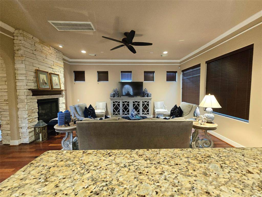 From the kitchen, you'll find an open and cozy family room, beautifully adorned with a double-sided gas fireplace, perfect for both relaxation and entertaining.