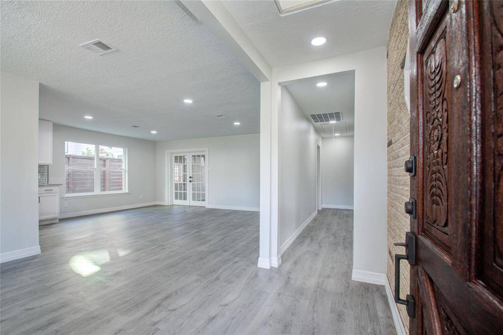 Front entrance with beautifully stained wood door.