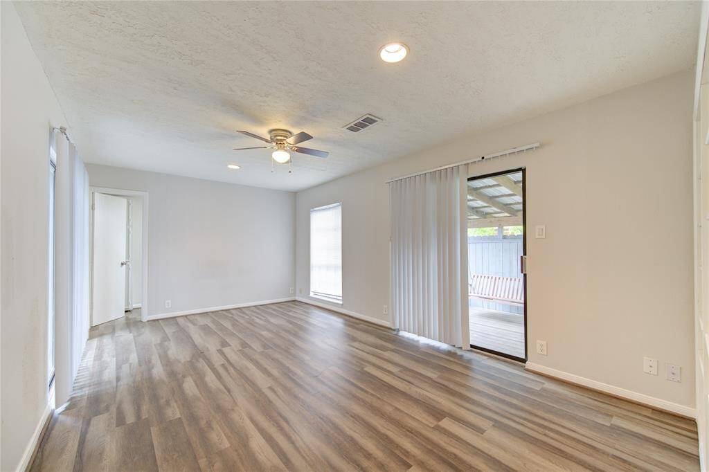 Another view of the large master bedroom with a whole wall of shelves.