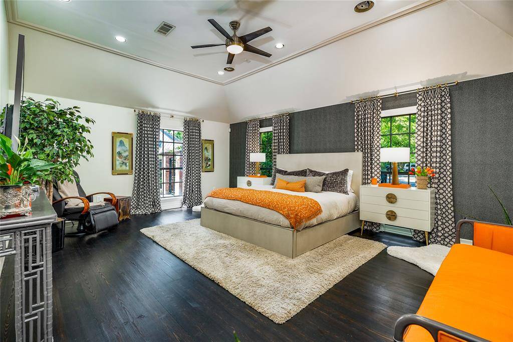 A restful night starts in the primary bedroom, where generous space and vaulted ceilings create an airy retreat.