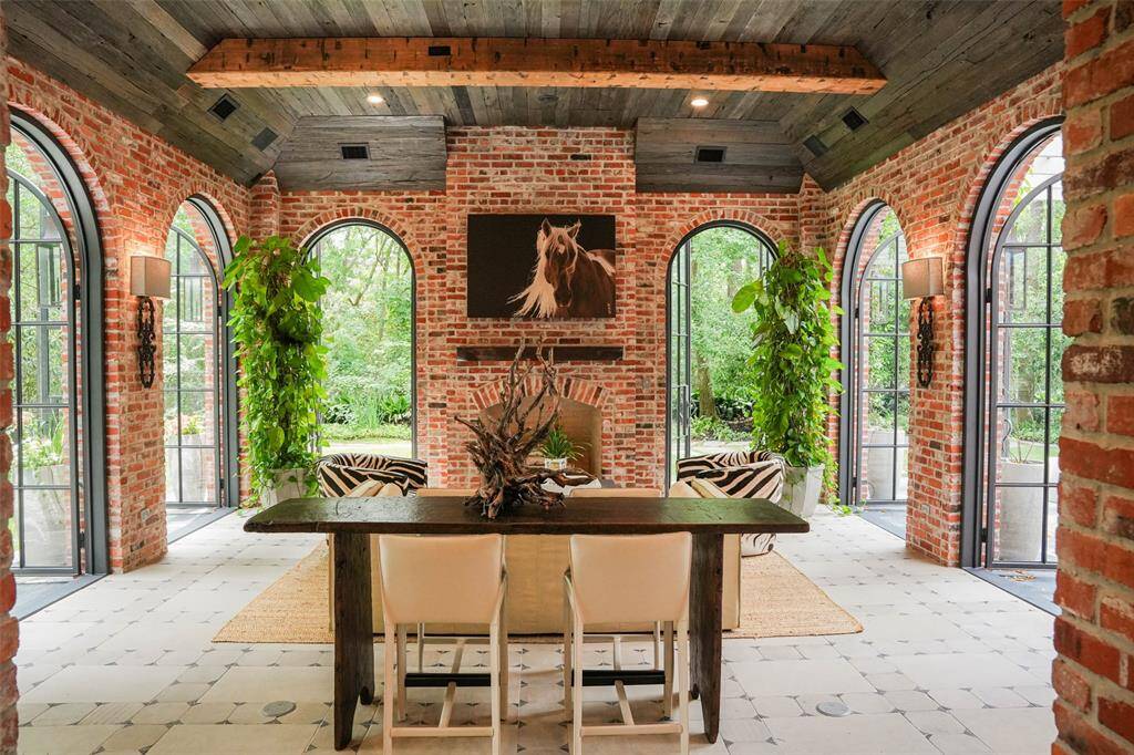 Your Formal Dining Room w/ Wood Paneling and Wonderful Arched Windows allowing natural light to gleam in!