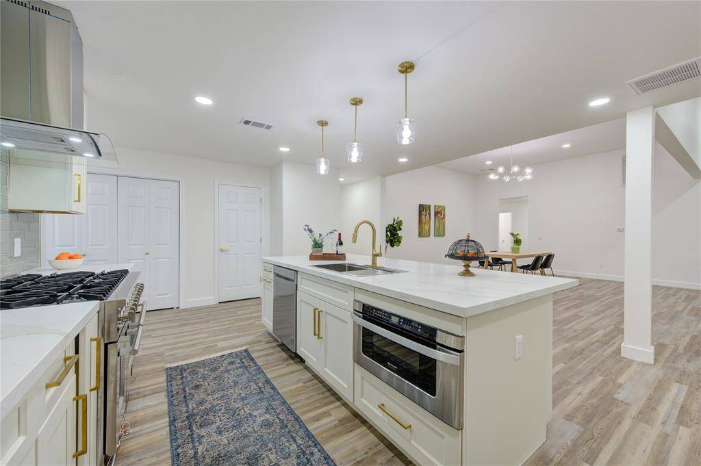 A 6-burner Professional Series Gas Range is the star of the kitchen, perfect for the home chef. The custom cabinetry offers plenty of storage, while new lighting fixtures brighten the entire space.