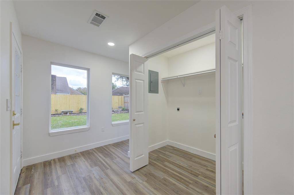 Conveniently located off the kitchen, the laundry room is both practical and efficient. It offers ample cabinet storage to keep cleaning supplies and household items organized. The space is designed for ease of use, with plenty of room for laundry tasks and folding.