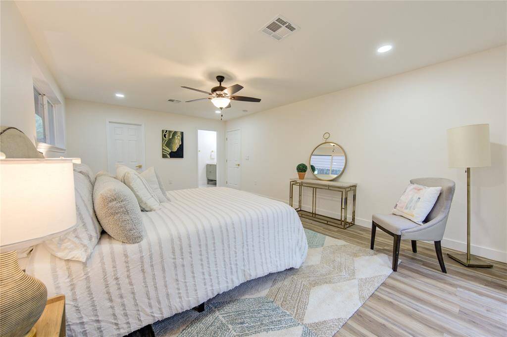 The freshly painted walls and modern trim create a clean, contemporary feel, making it a relaxing space to unwind. Ample room is provided for a king-sized bed and additional furniture, creating a comfortable and cozy atmosphere. This peaceful retreat is perfectly designed to complement the home’s updated finishes and open layout.