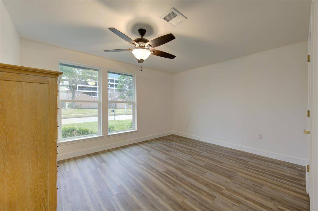 The home features two spacious secondary bedrooms, each designed with comfort and style in mind. Both rooms boast luxury vinyl flooring, providing a sleek and durable surface that is easy to maintain. Large new windows allow for plenty of natural light, creating a bright and inviting atmosphere.