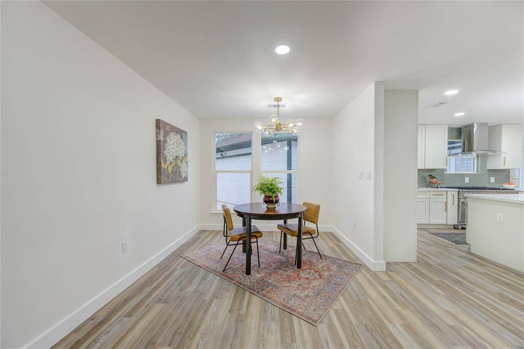 The breakfast room is a charming, sunlit space located just off the kitchen, perfect for casual dining or enjoying a morning cup of coffee. Surrounded by large windows that flood the room with natural light, this area offers a bright, inviting atmosphere to start your day.