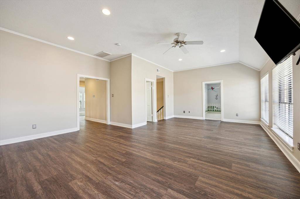 Elegant crown molding, recessed lighting, and durable luxury vinyl plank flooring add sophistication and functionality, making this flexible space perfect for your needs.