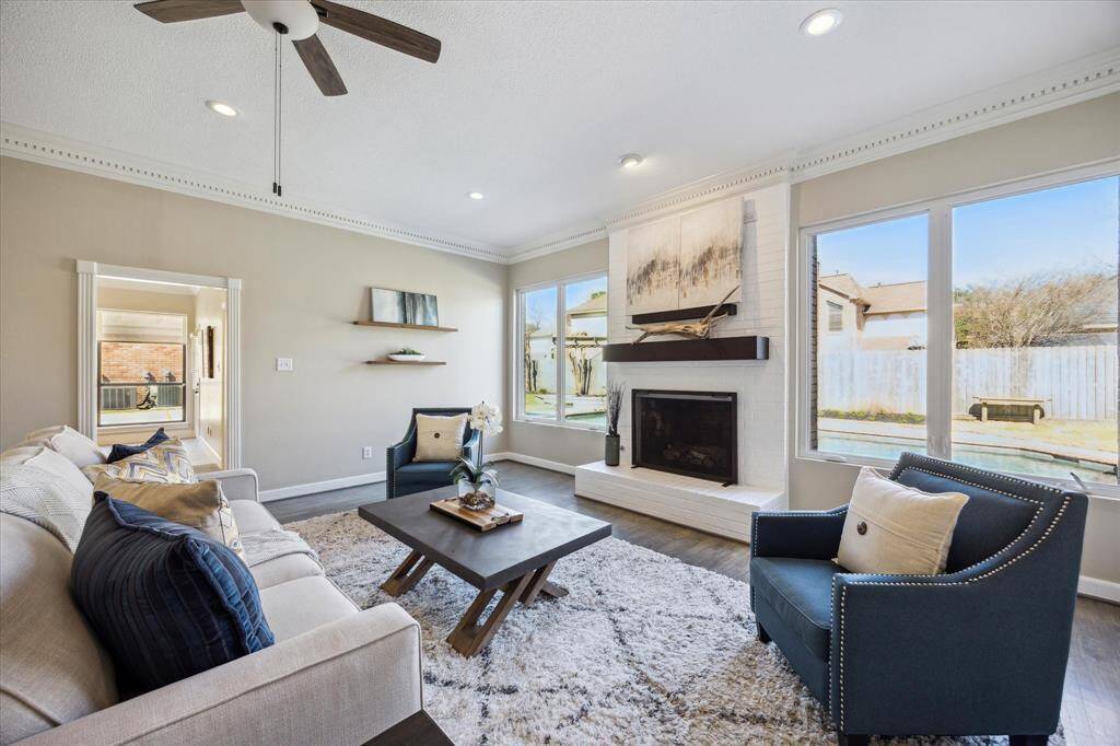 The family room blends comfort and elegance, featuring large casement windows that fill the space with natural light and showcase serene backyard views.
