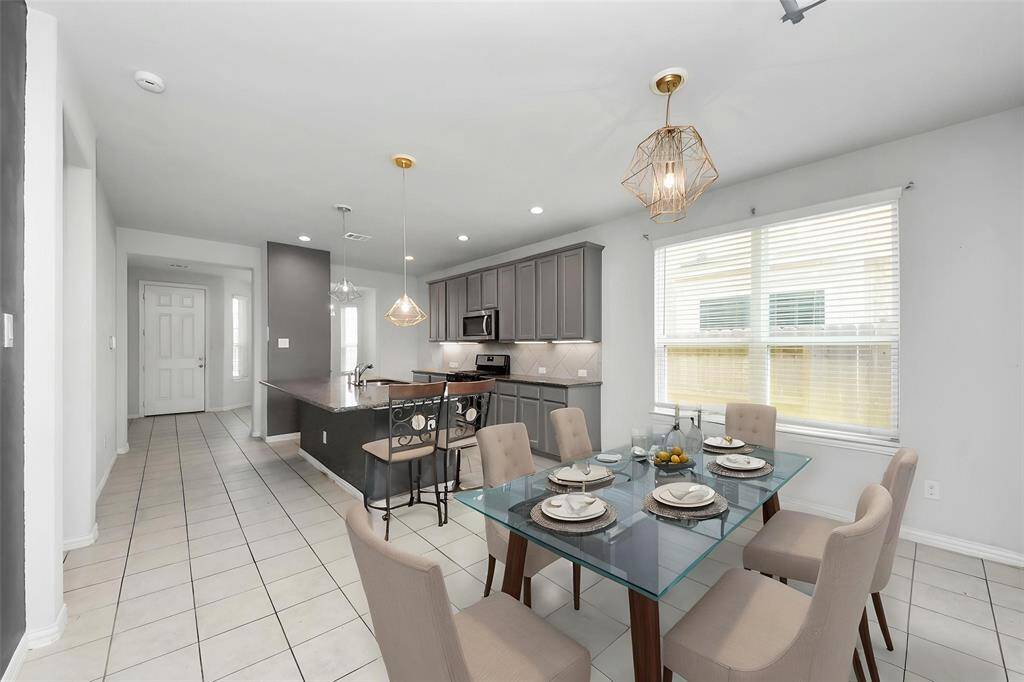 Charming single-story brick home with a two-car garage and a well-maintained front yard. Features a welcoming arched entryway and a clean, modern design. Perfect for comfortable family living.