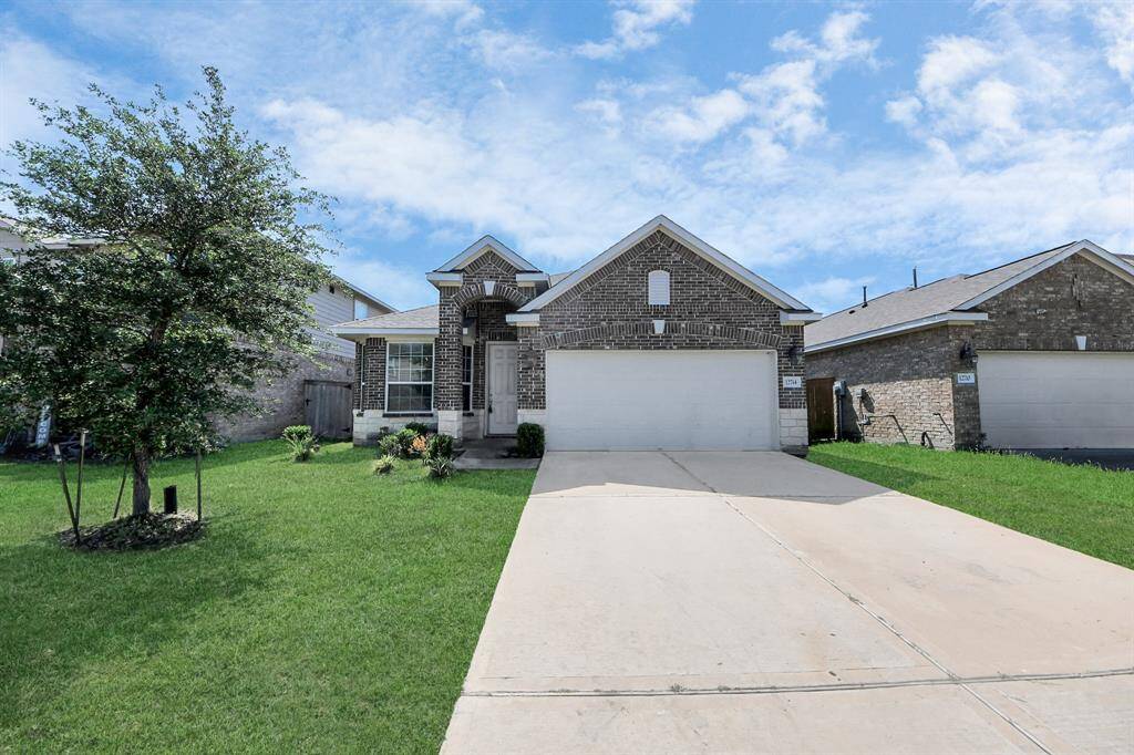 This charming single-story brick home features a tidy front yard with a well-maintained lawn. It includes a double garage and a welcoming entrance, perfect for a comfortable family living.