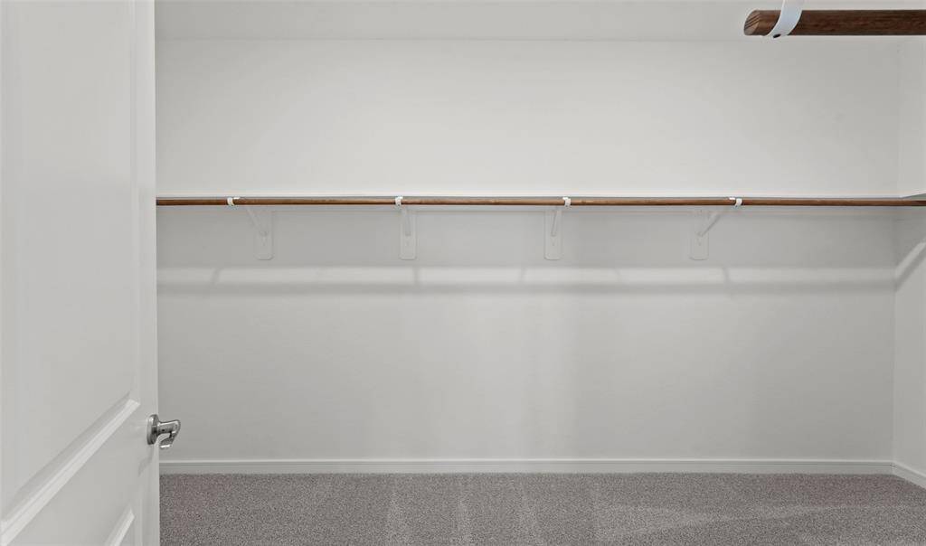 Walk-in closet in primary suite (*Photo not of actual home and used for illustration purposes only.)