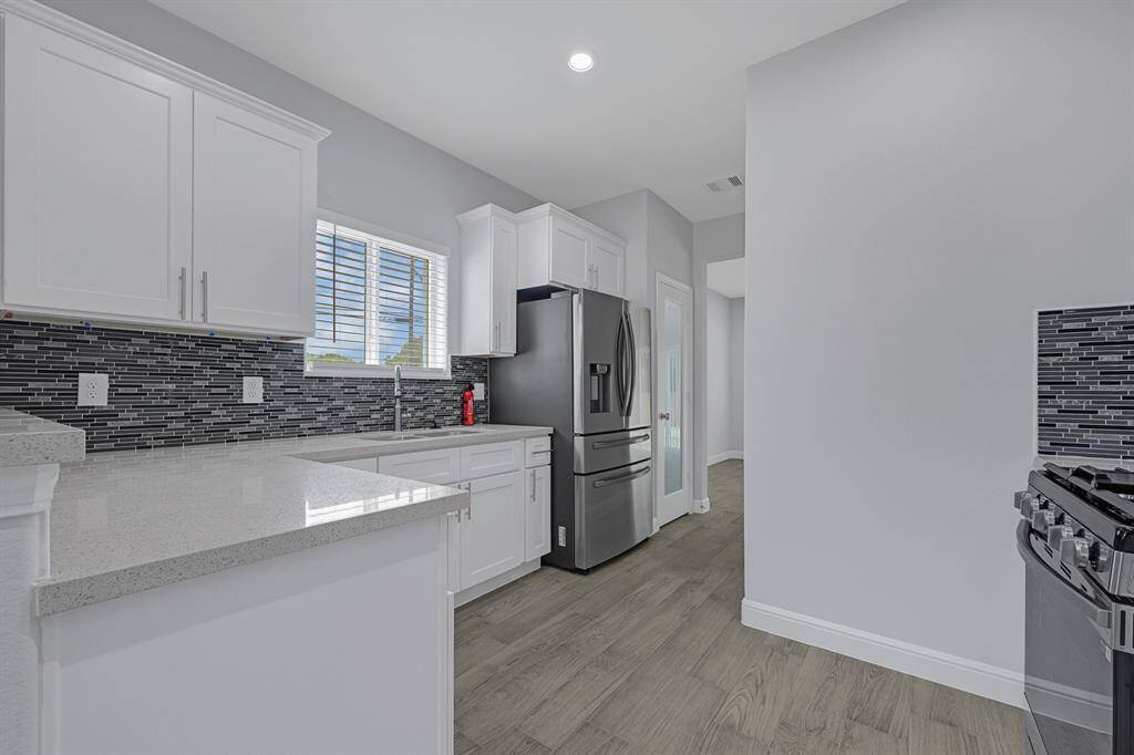 Updated kitchen with modern appliances and ample cabinetry.