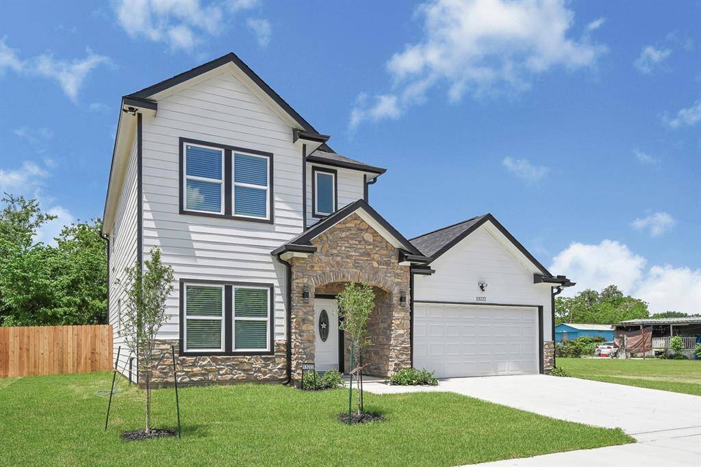 Charming two-story brick facade with manicured landscaping.