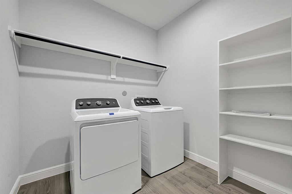 Dedicated laundry room with storage and organization space.