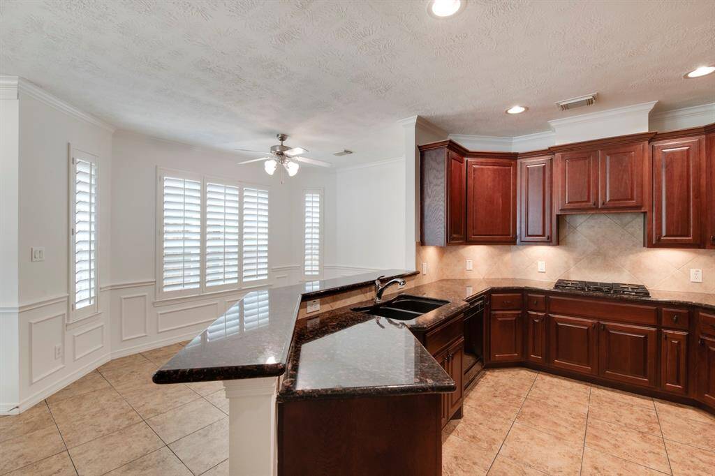 Kitchen has breakfast bar for additional seating.
