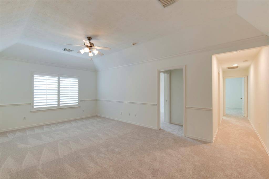 Large second floor game room/living room. Space has new carpet (2025), new interior paint (2025) and plantation shutters