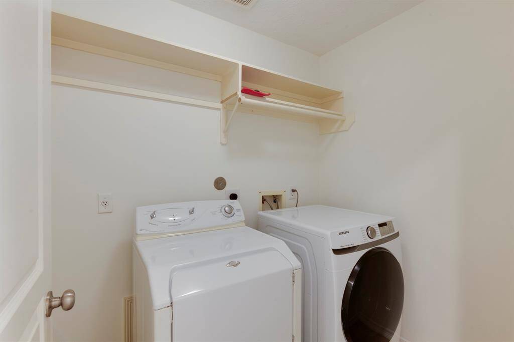 Laundry room has shelves, and hanging rod. Washer and Dryer stay with the home.
