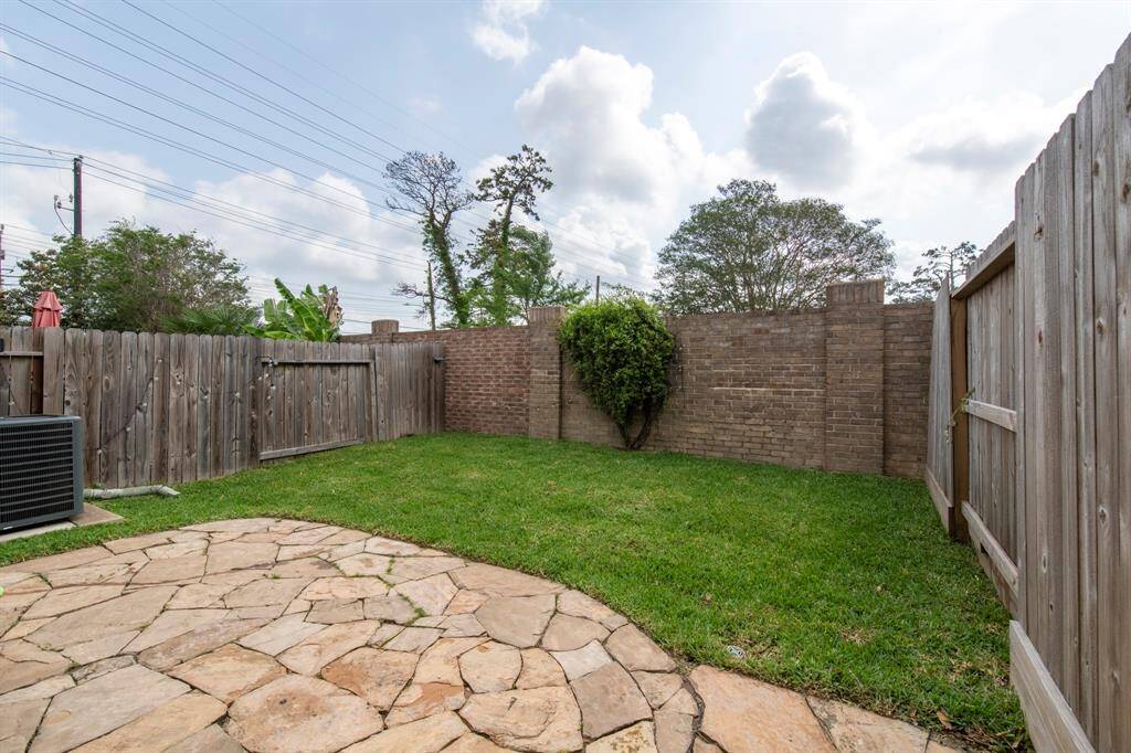 Private backyard has flagstone patio and newly planted sod (2025).