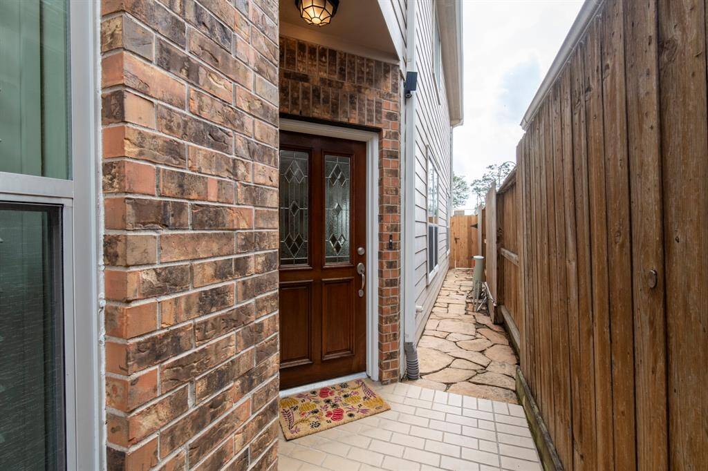 Private entry. Path leads to gated backyard. New backyard gate (2025)