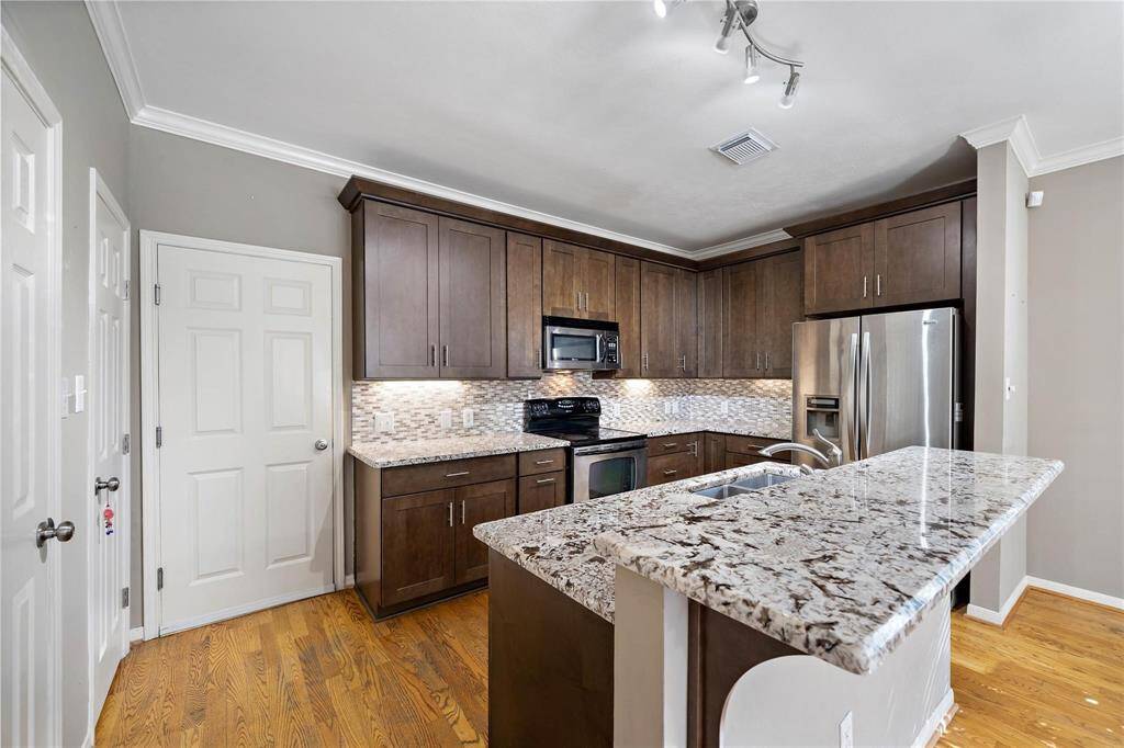 A well-equipped kitchen showcasing ample storage options and gleaming stainless steel appliances