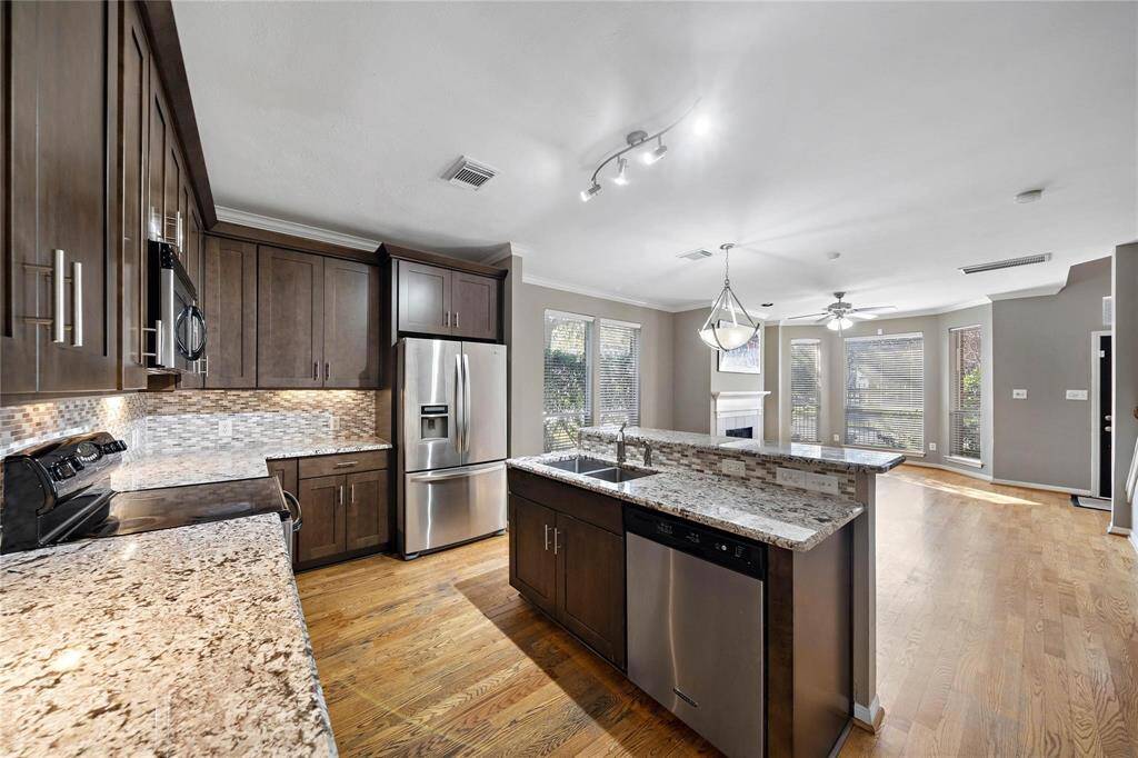 An open-concept kitchen seamlessly integrates with the dining and living areas. Perfect for entertaining