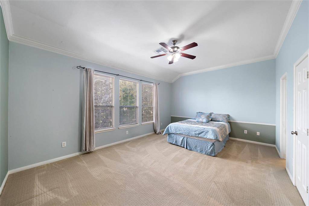 Primary bedroom flooded with natural light, perfect for unwinding and starting the day refreshed