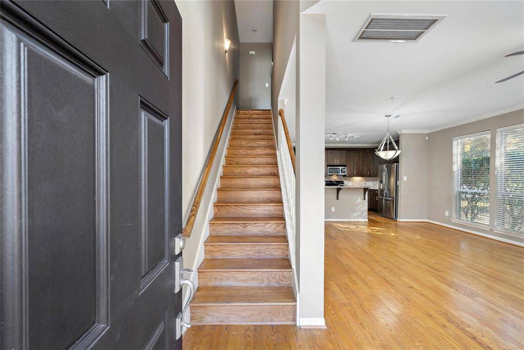 A staircase gracefully greets you as you step into the home, inviting exploration and adding architectural elegance to the entryway