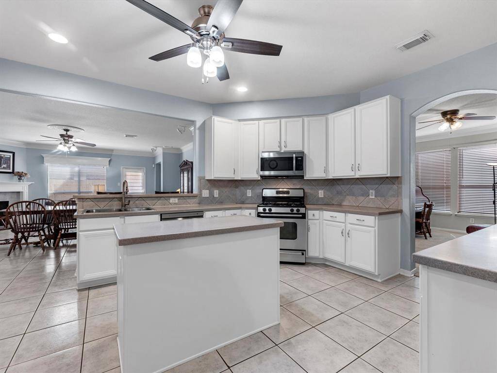 This view shows the kitchen open to the family room, as well as, the dining room to the right. The dining room is currently being used as a home office.