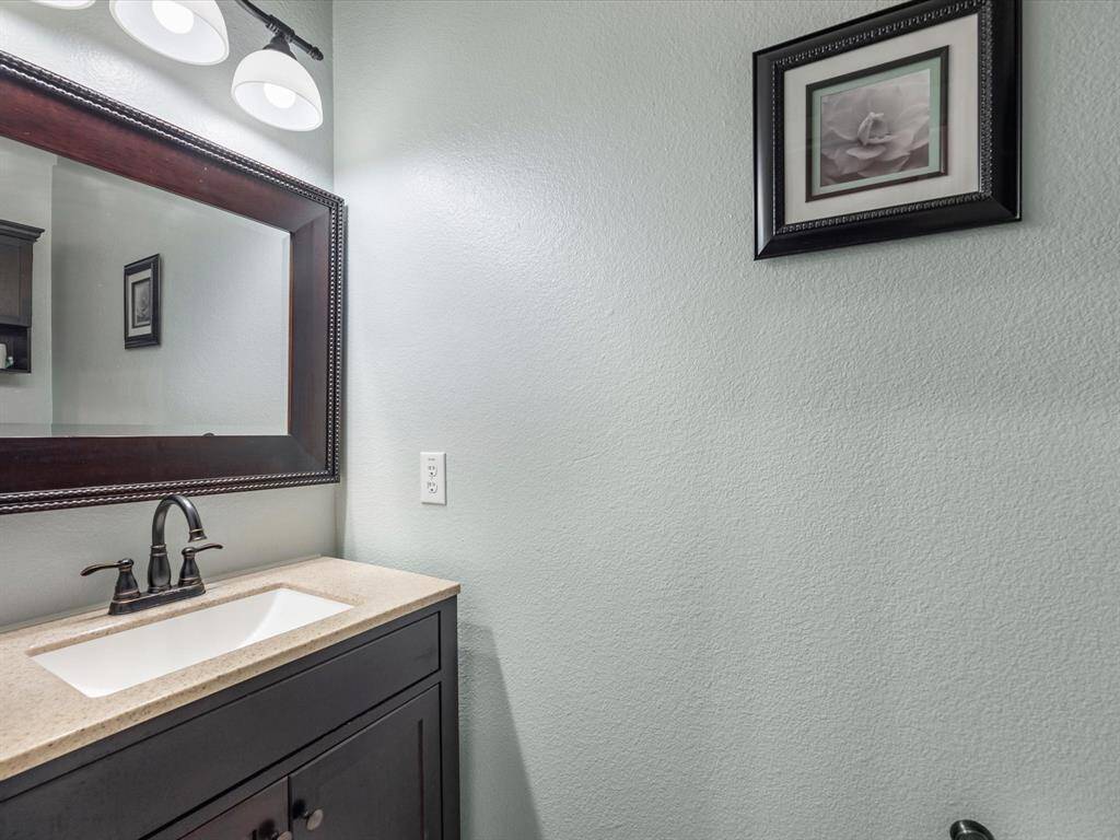 The powder room is tucked under the stairs and nicely updated.