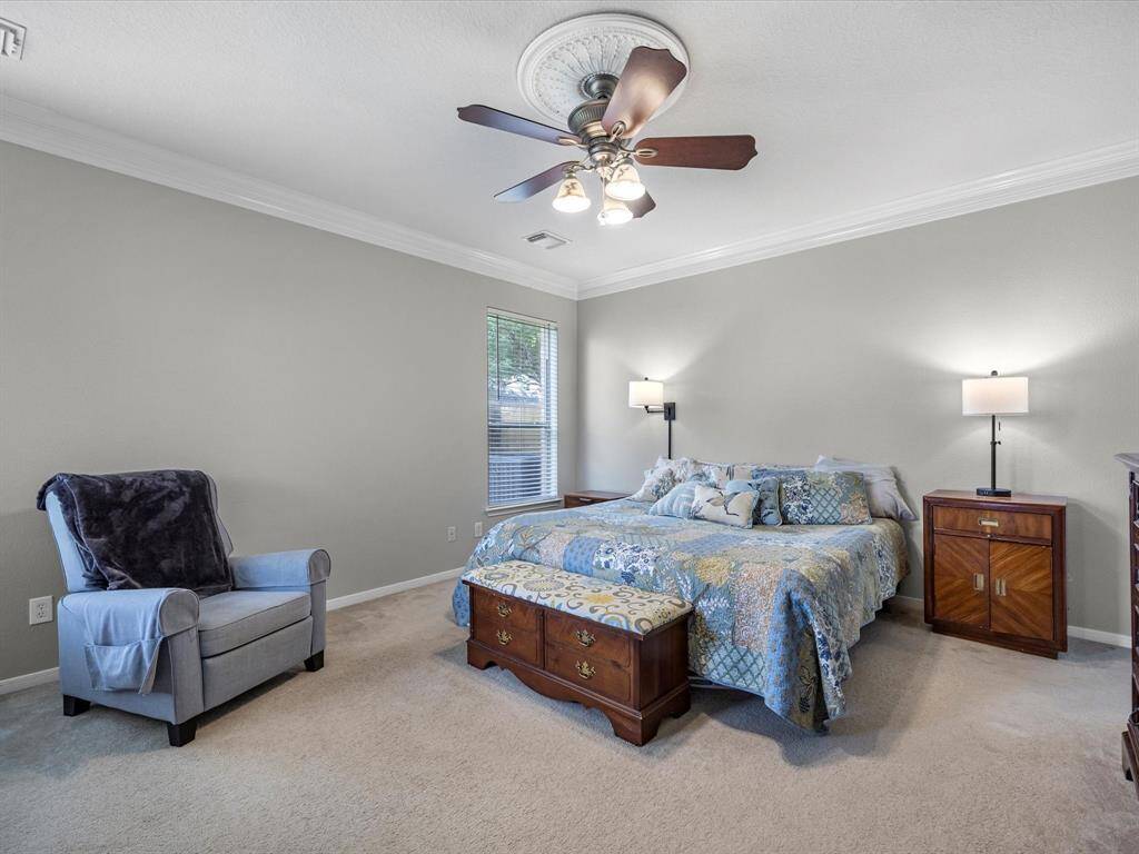 The large primary is downstairs and has room for a sitting area.