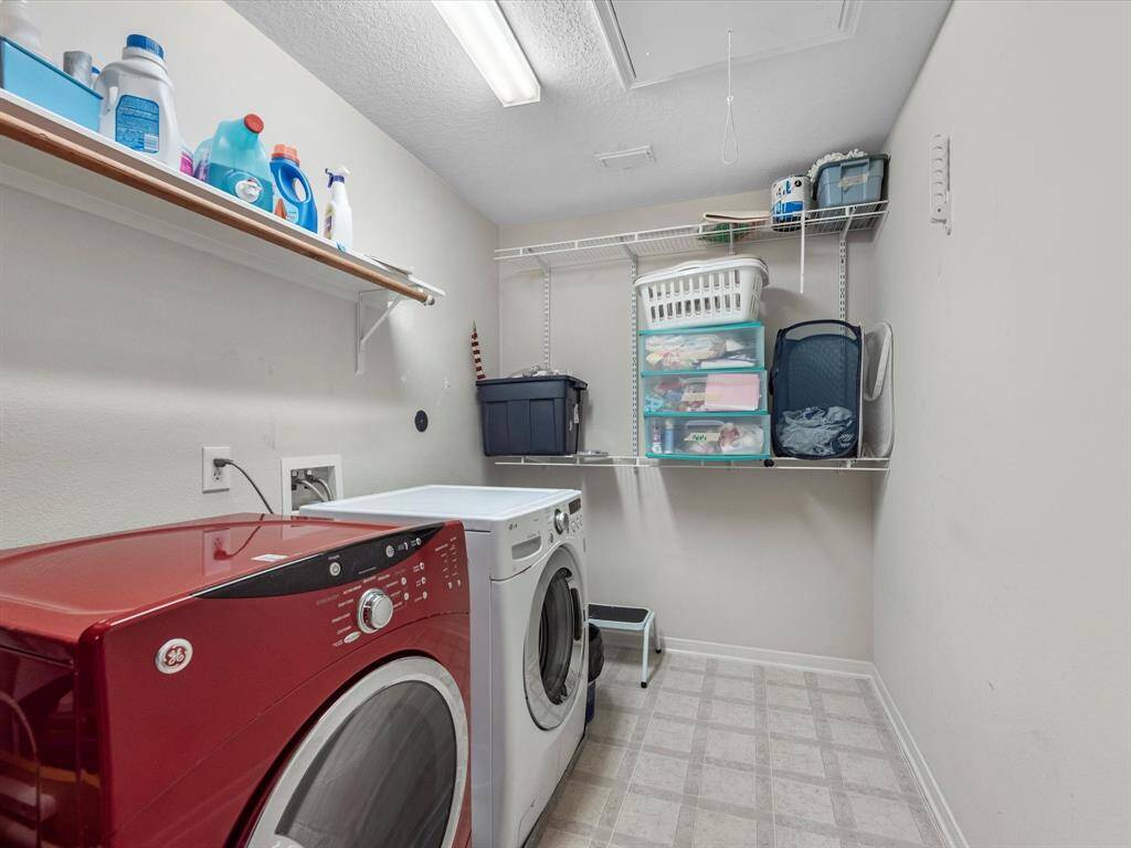 The laundry room is also upstairs for convenience and has plenty of shelving for storage.