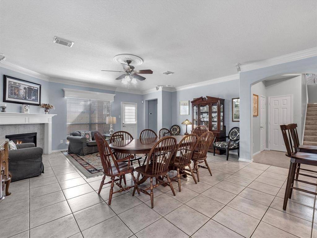 The open plan is spacious with a cozy fireplace in the family room and the kitchen overlooking everything.
