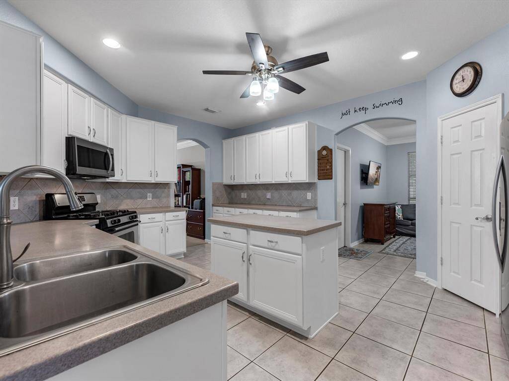 The island kitchen has plenty of storage in so many cabinets! Plus tons of counter top space. The pantry has plenty of room as well. And there's gas cooking.