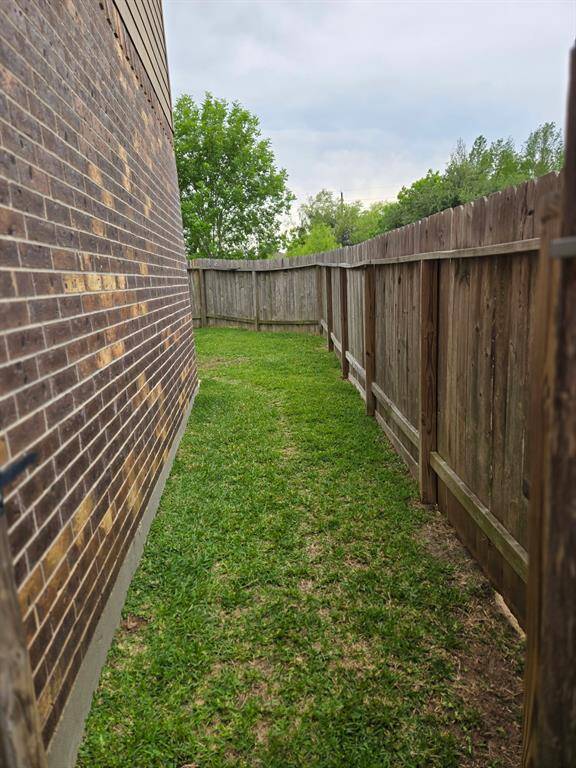 This shot show the brick on the first level and the side yard.