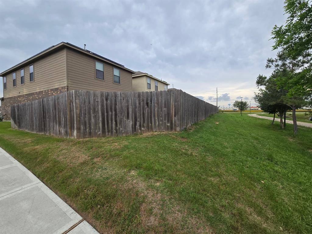 This view shows the back of the home and the walking trail behind the house. Enjoy long walks on the trail or make it part of your exercise route.