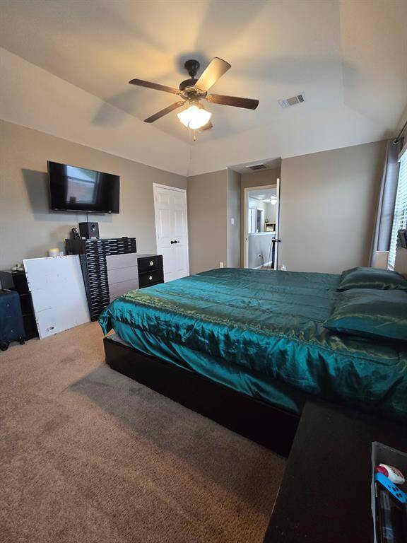 Large primary bedroom with high ceilings.