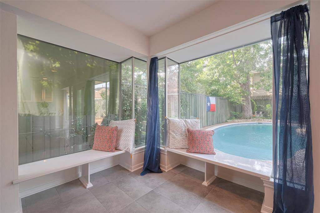 Breakfast room  offers a view of the pool and outdoor area, creating a seamless indoor-outdoor living experience.