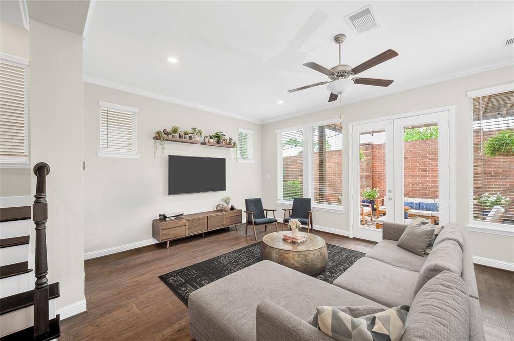 Light-filled first-floor family room featuring beautiful hardwood flooring—warm, inviting, and perfect for entertaining.