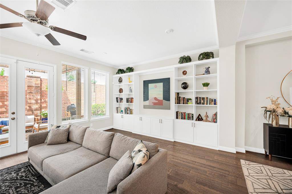 Gleaming hardwood floors and natural light enhance this open-concept living room—perfect for gathering or unwinding.