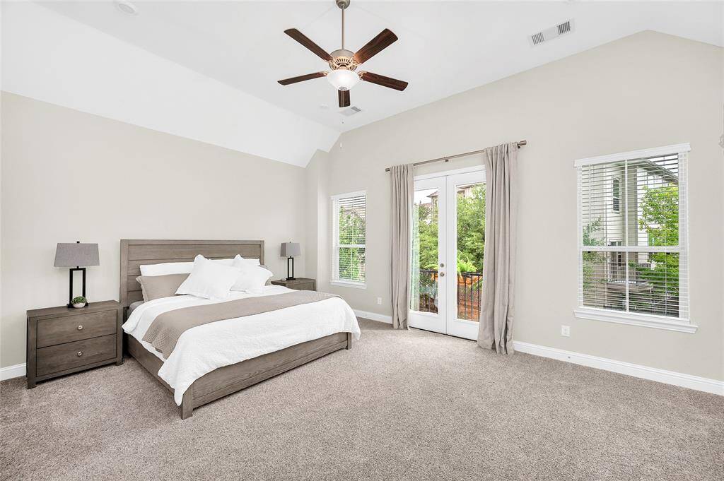 Spacious primary suite with ample natural light, high ceilings, and room for a sitting area—your private retreat.