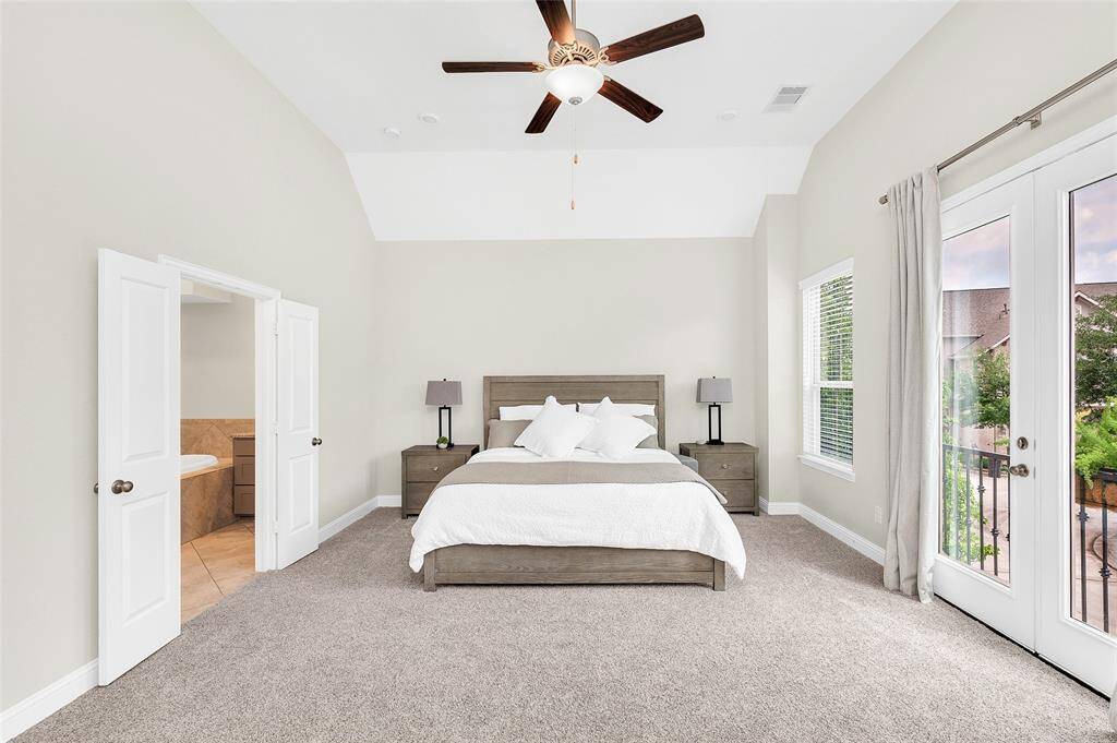 The primary suite includes a luxurious en-suite bath with dual vanities, a soaking tub, and a separate shower.