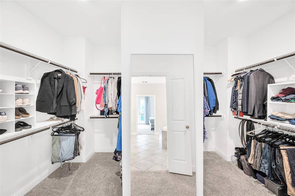 The spacious walk-in closet in the primary suite offers ample storage with built-in shelving and plenty of room for your wardrobe.