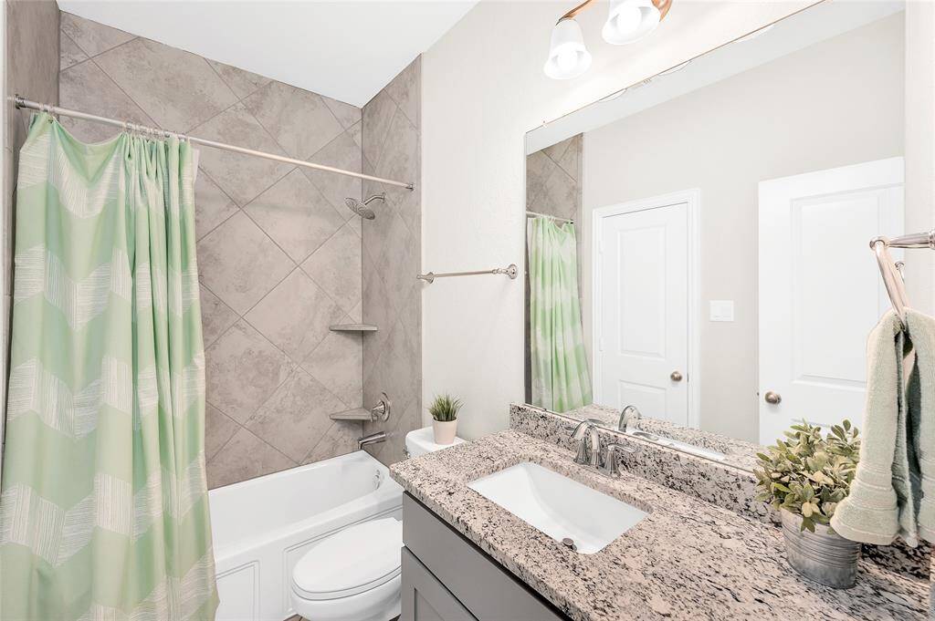 Convenient full bathroom on the second floor, featuring a bathtub with a shower, ample storage, and modern finishes—ideal for family and guests.