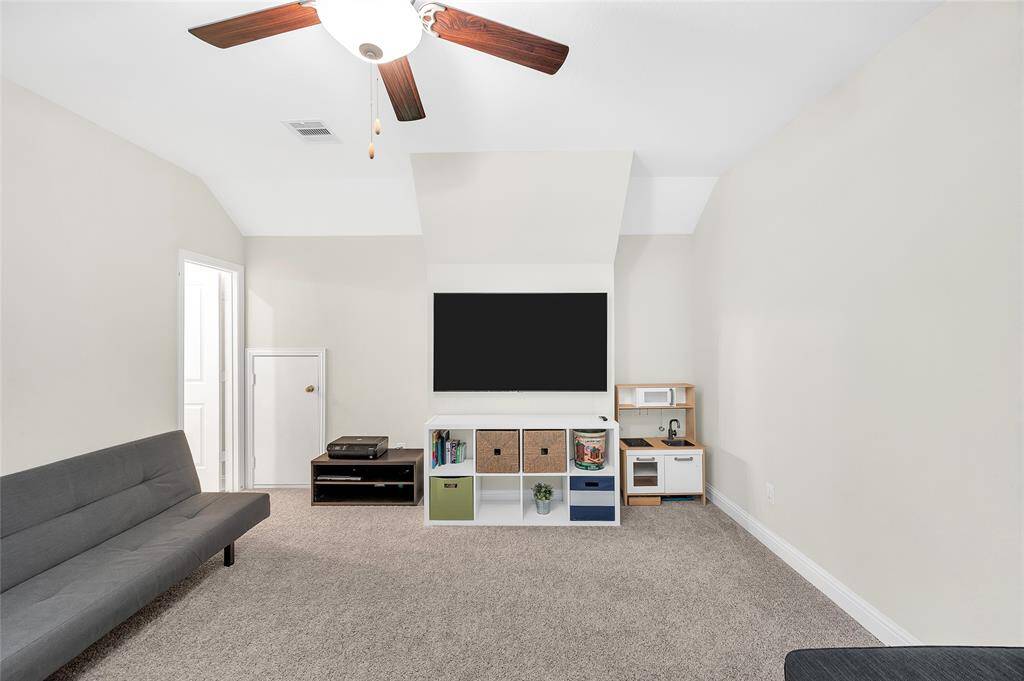 The third floor offers a spacious flex/game room with an office area and full bath—an ideal private retreat for guests or a quiet workspace.