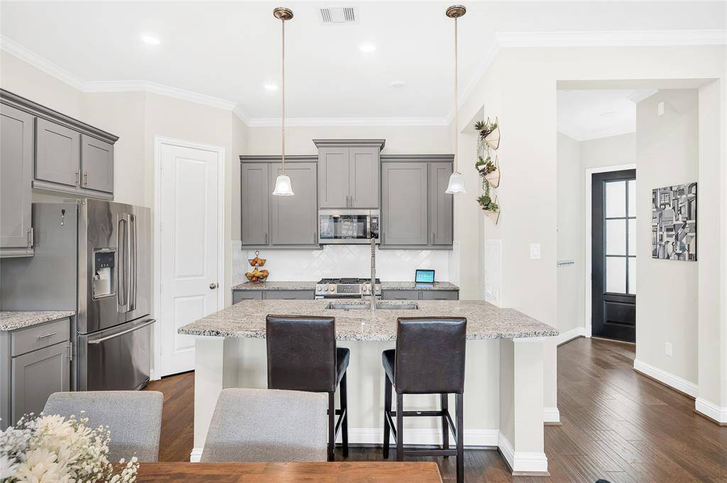 Stunning open kitchen featuring durable granite countertops and a spacious island.