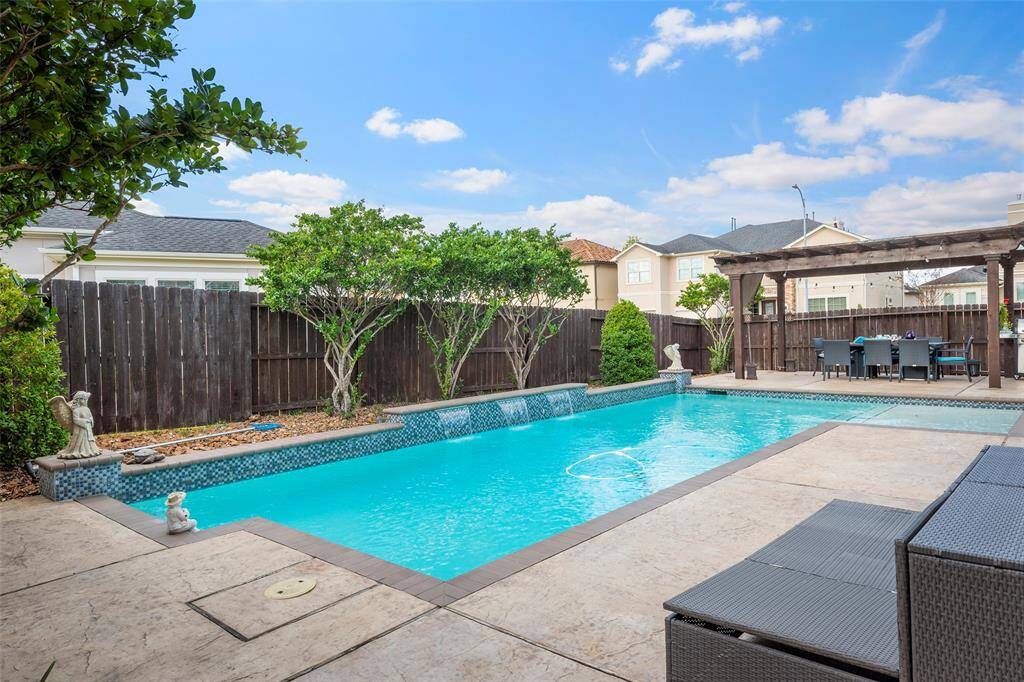 this inviting pool, fire pit and pergola