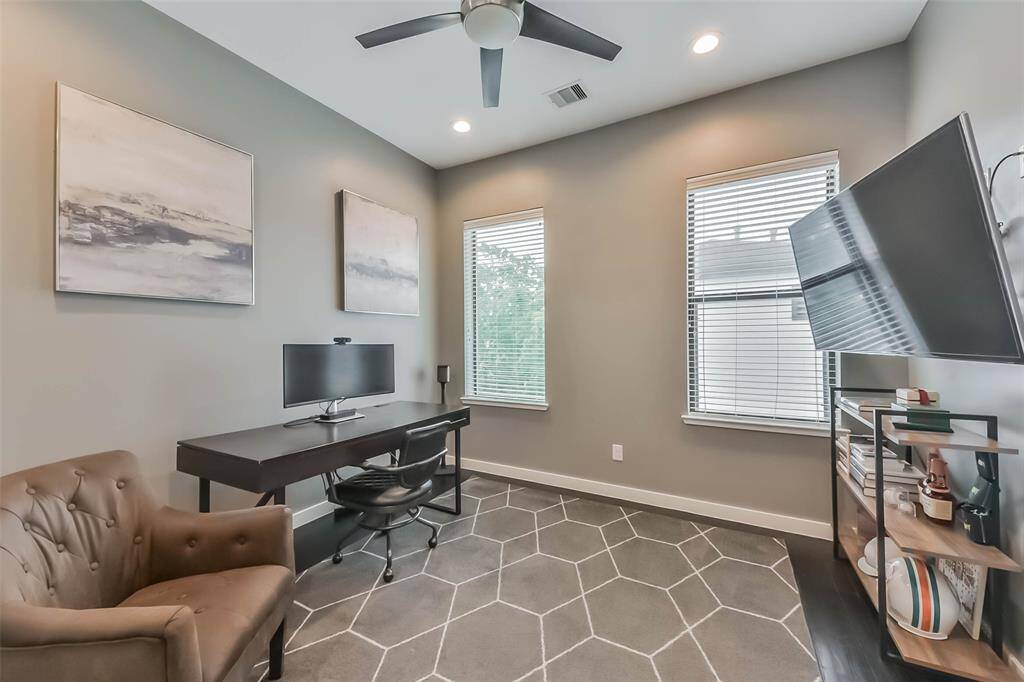 This versatile secondarybedroom doubles as a homeoffice, featuring two largewindows with blinds for naturallight and privacy. Recessedlighting and a neutral colorpalette create a bright yet cozyambiance. The room boasts darkhardwood flooring and amplespace, making it ideal for a guestroom, study, or flex space to suityour needs.