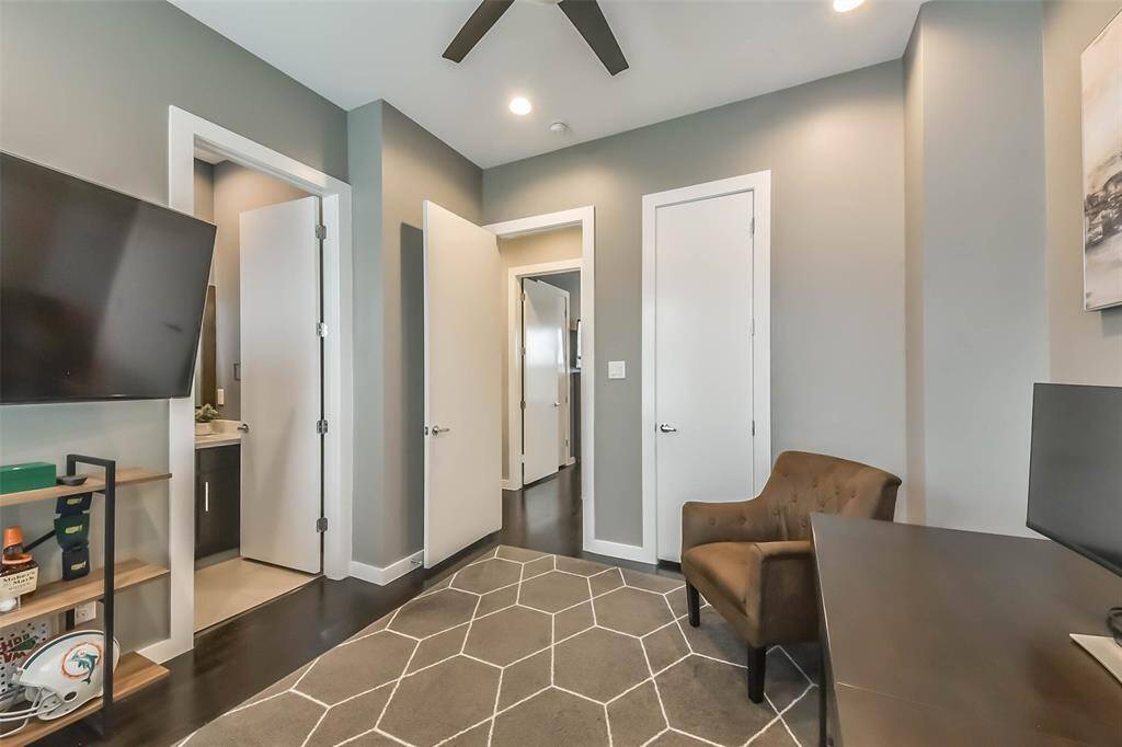 This versatile secondarybedroom doubles as a homeoffice, featuring two largewindows with blinds for naturallight and privacy. Recessedlighting and a neutral colorpalette create a bright yet cozyambiance. The room boasts darkhardwood flooring and amplespace, making it ideal for a guestroom, study, or flex space to suityour needs.