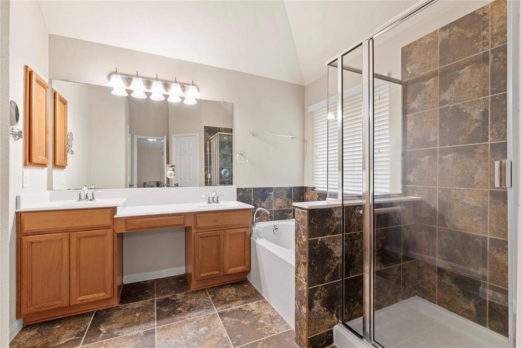 Primary bathroom is complete with a dual dink vanity, soaking tub, separate shower and a walk-in closet.
